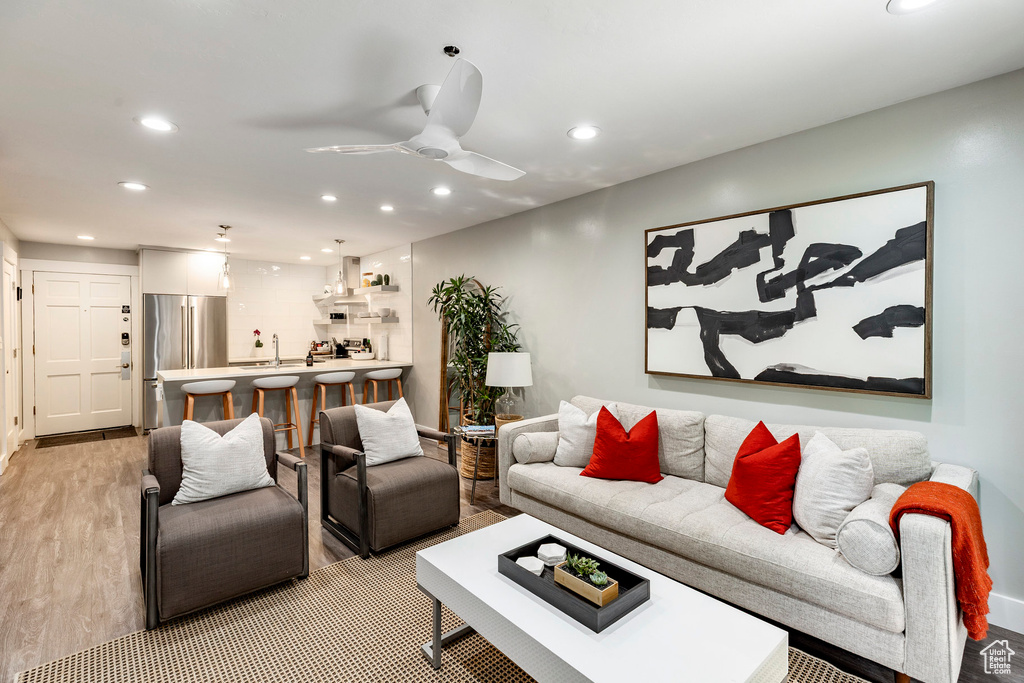 Living room featuring recessed lighting, light wood-type flooring, and ceiling fan