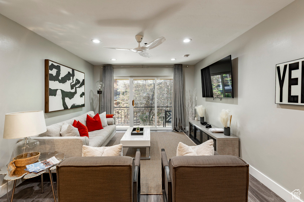 Living room with wood finished floors, ceiling fan, and recessed lighting