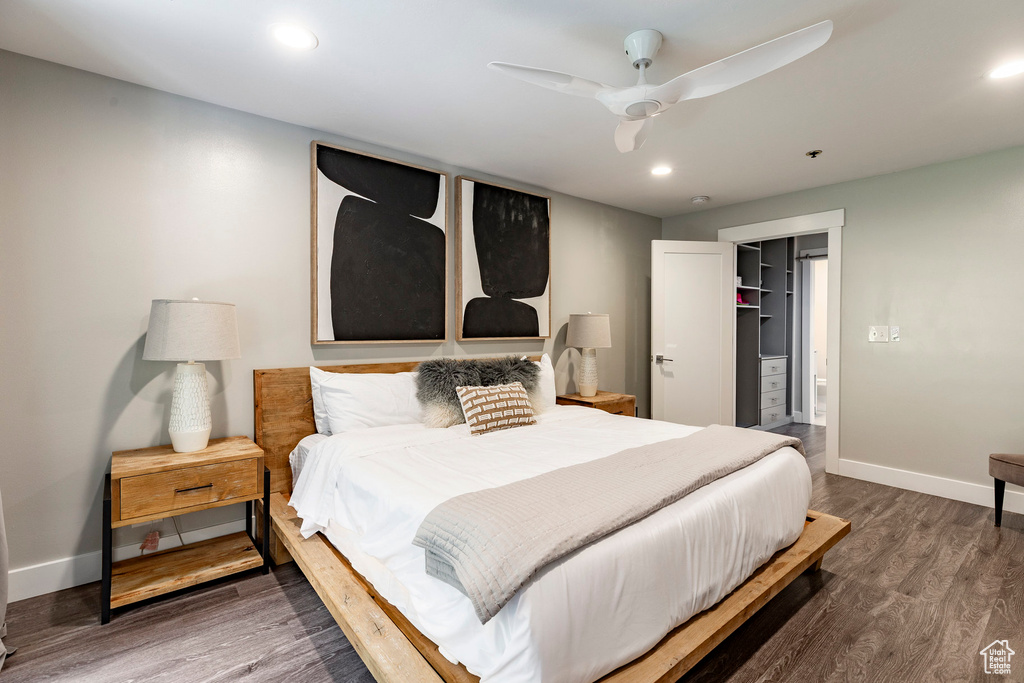 Bedroom with wood finished floors, a walk in closet, recessed lighting, a ceiling fan, and a closet