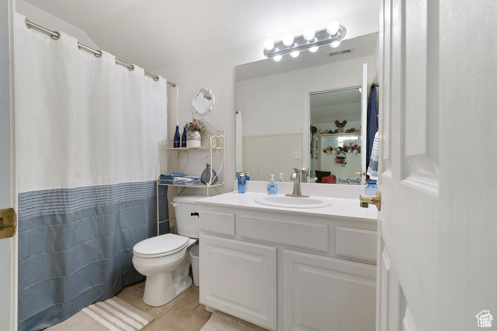 Full bath featuring tile patterned floors, vanity, and a shower with shower curtain