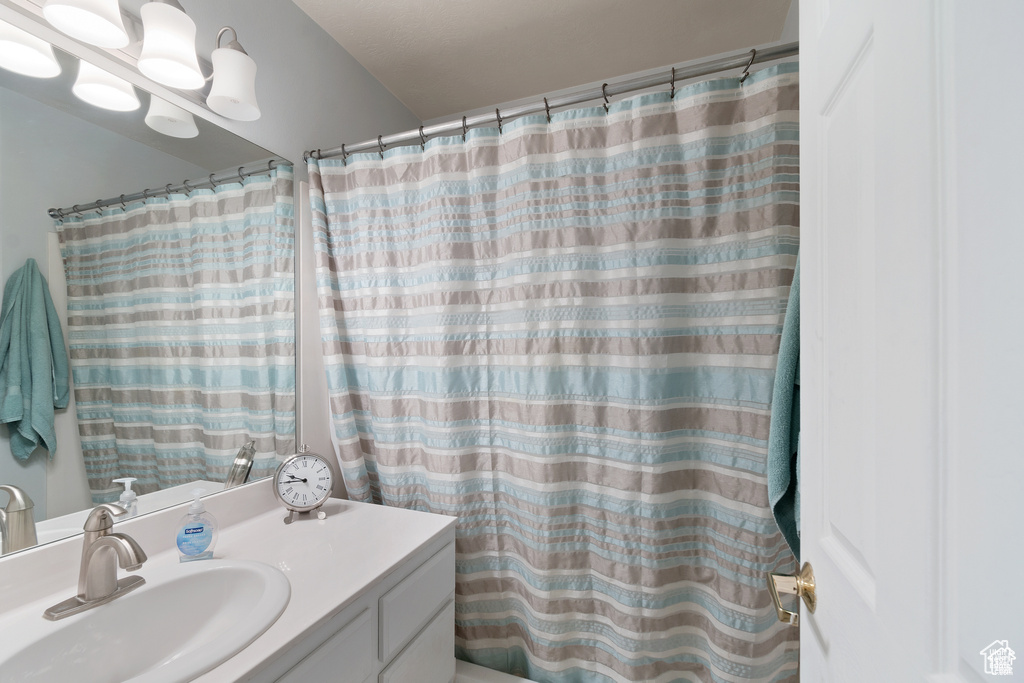 Bathroom featuring vanity and a shower with shower curtain