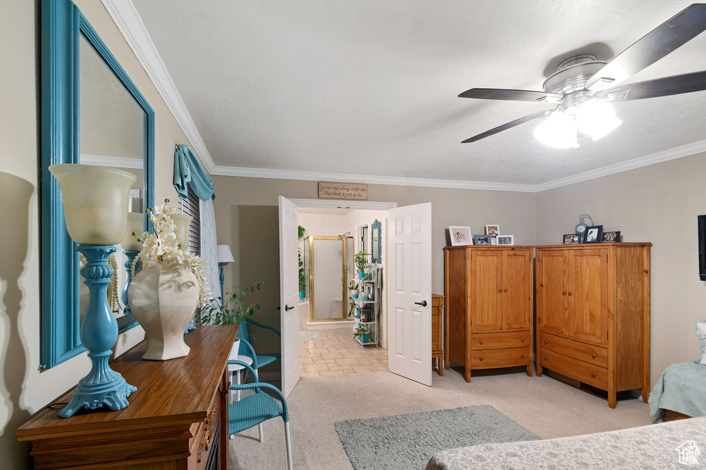 Bedroom featuring crown molding, light colored carpet, and ceiling fan