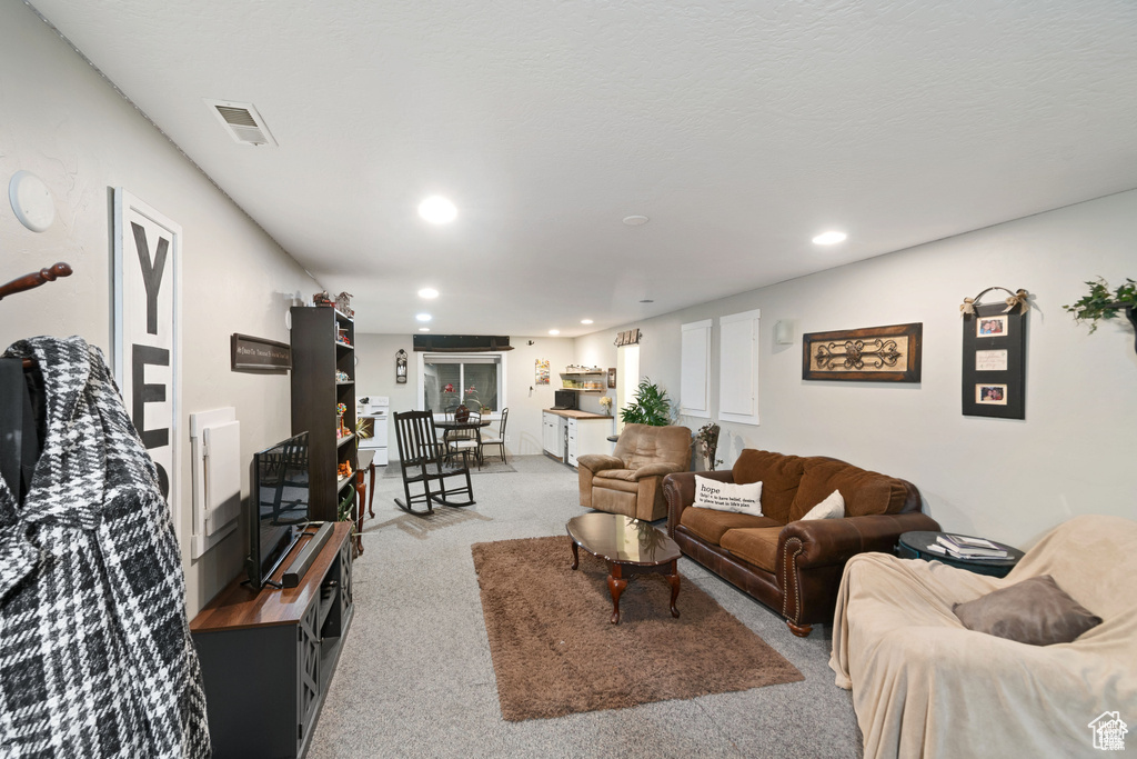 Living room featuring carpet flooring and recessed lighting