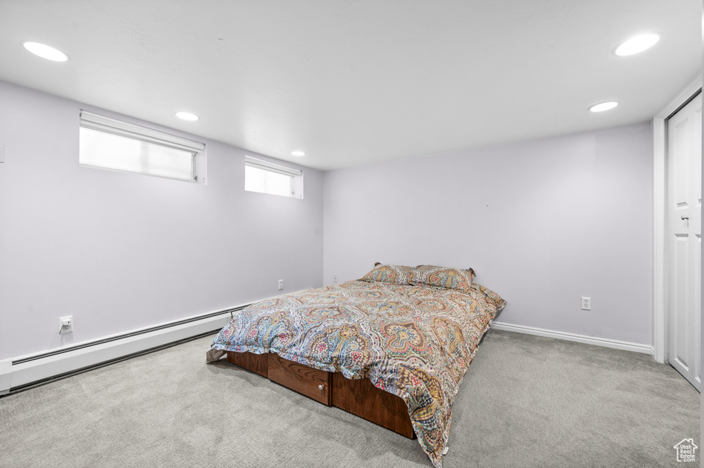 Bedroom featuring carpet, recessed lighting, and a baseboard heating unit