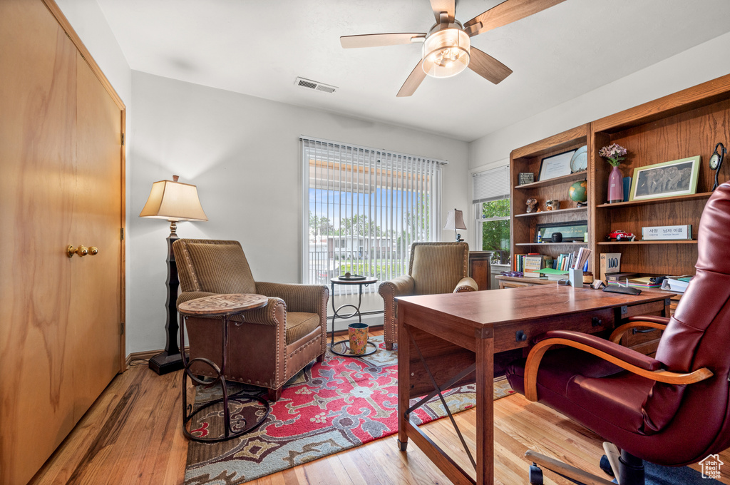 Office area with hardwood / wood-style flooring and a ceiling fan