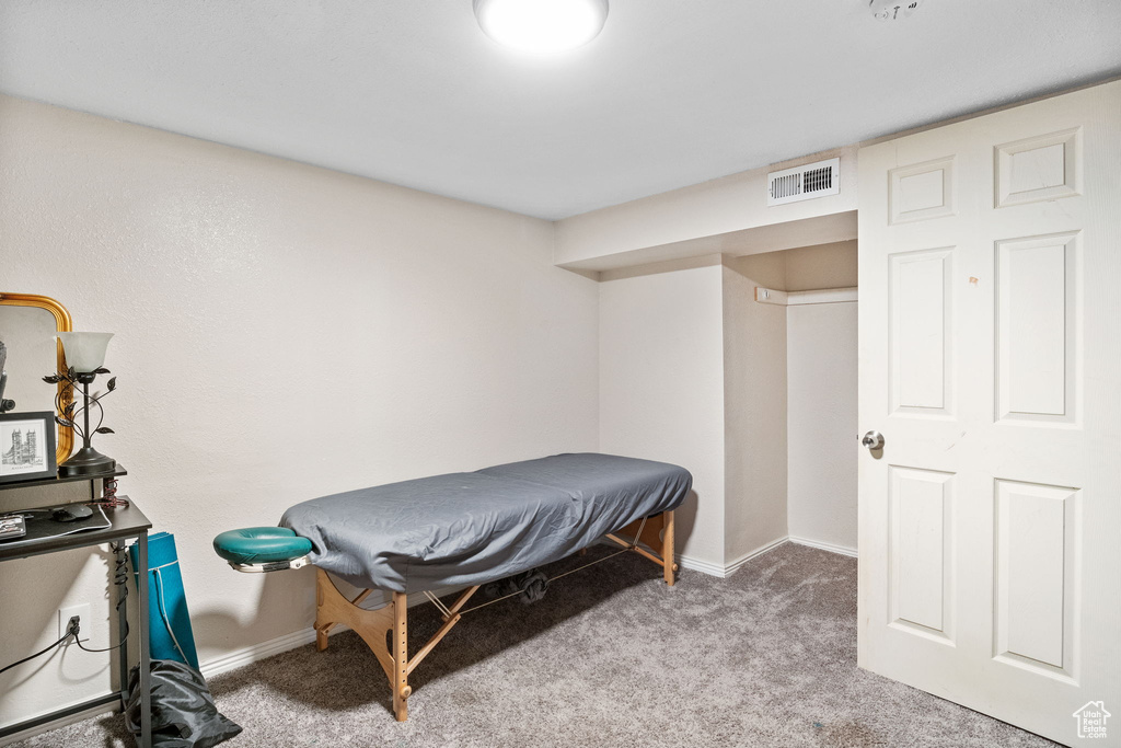 Bedroom featuring carpet floors and baseboards