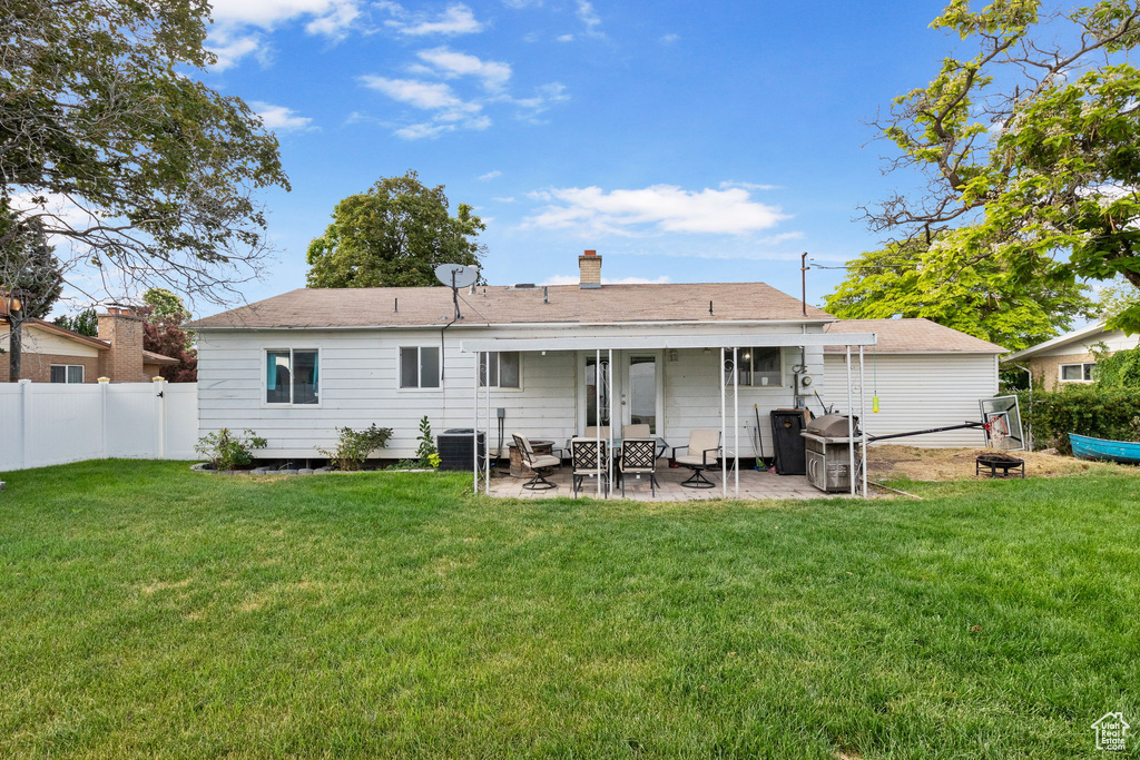 Back of house with a patio area, an outdoor fire pit, and a chimney