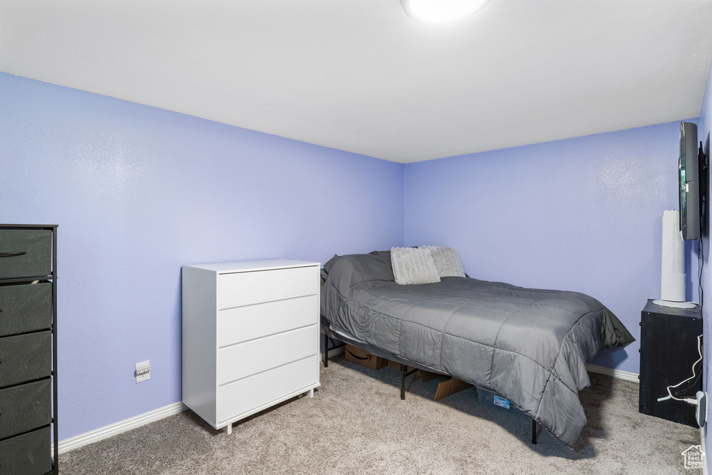 Carpeted bedroom with baseboards
