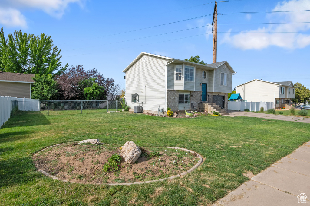 View of side of property featuring driveway, an attached garage, and brick siding
