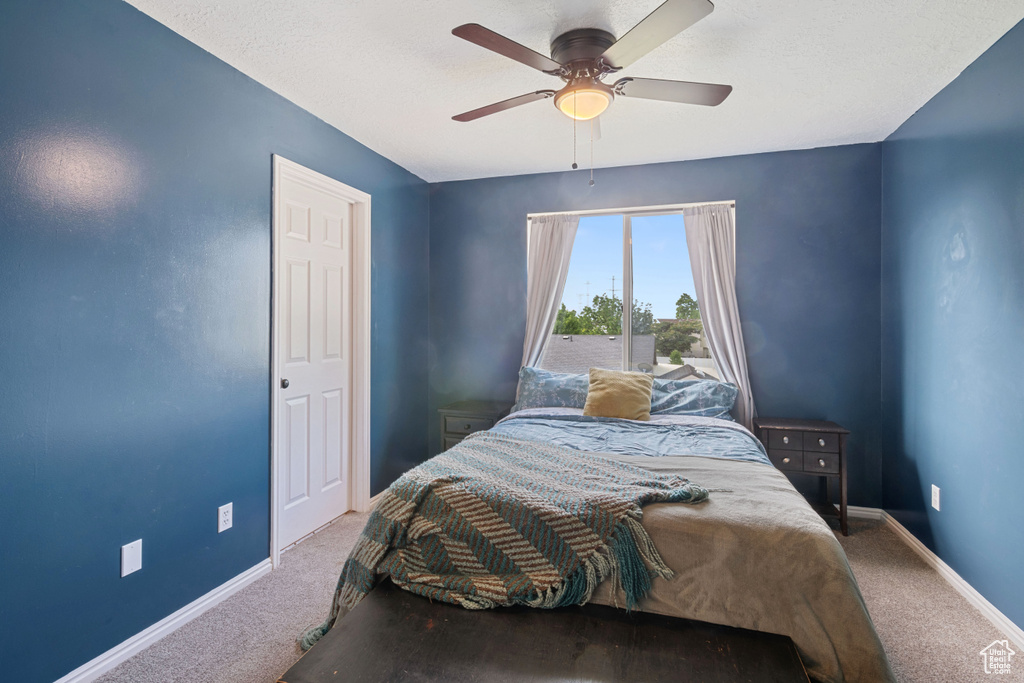 Bedroom with carpet floors and a ceiling fan