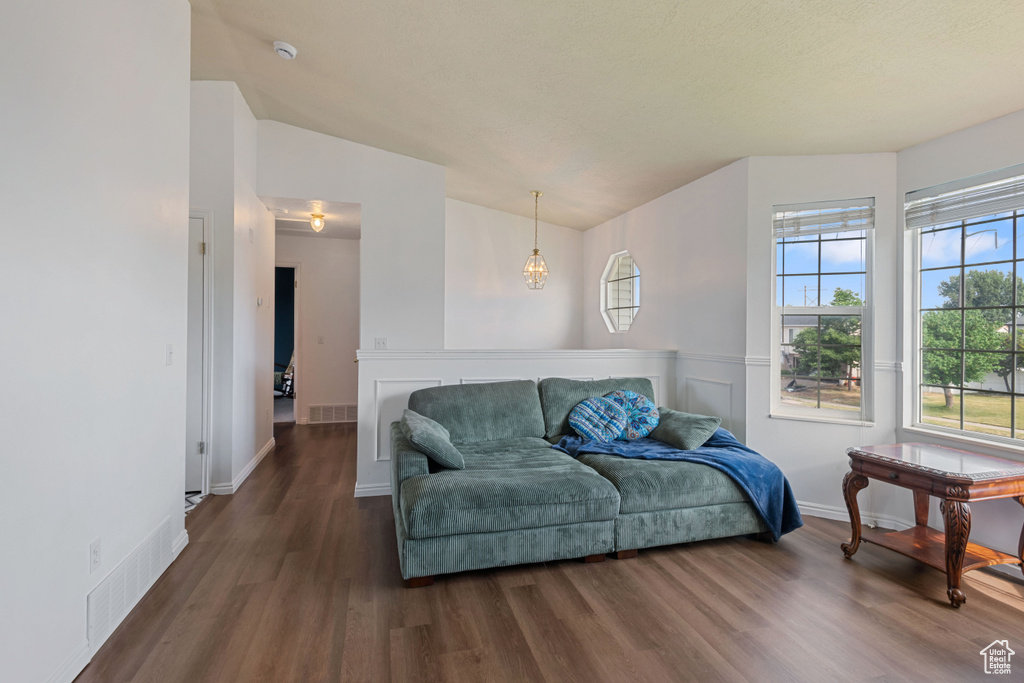 Living room with wood finished floors and a wainscoted wall