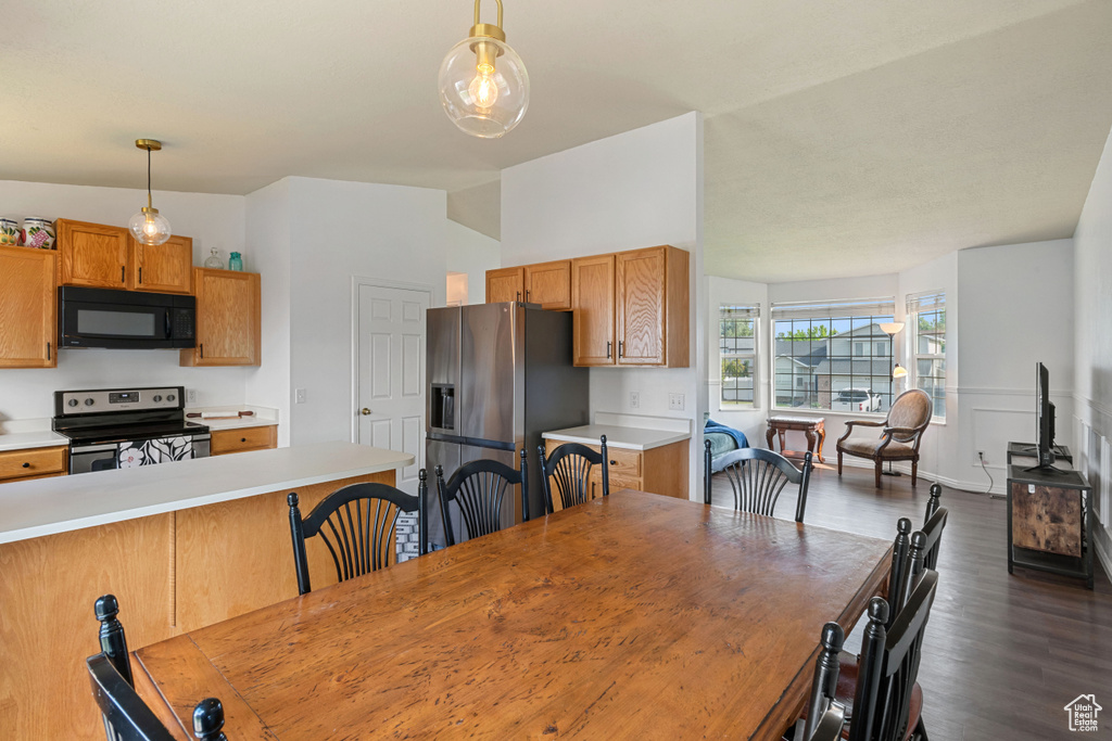 Dining room featuring dark wood-style floors
