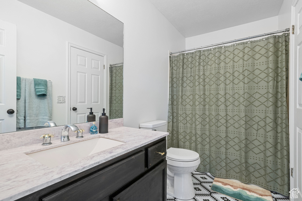 Full bath featuring vanity and curtained shower