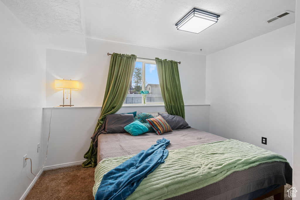 Carpeted bedroom featuring baseboards