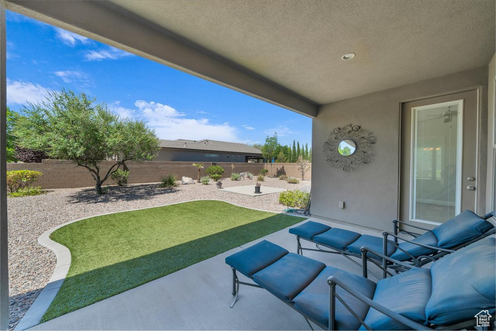 Fenced backyard featuring a patio area and an outdoor hangout area