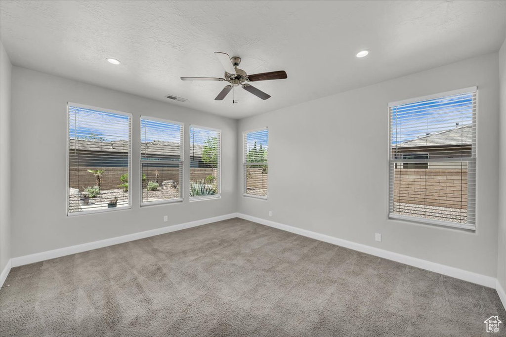 Spare room featuring carpet, ceiling fan, and recessed lighting