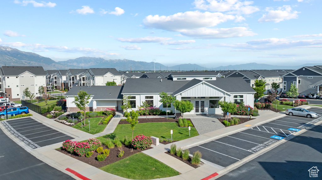 View of property featuring a residential view, uncovered parking, and a mountain view