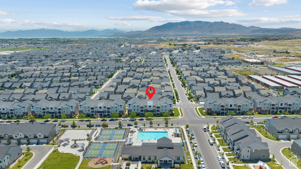 Aerial view of property's location featuring a mountain backdrop and nearby suburban area