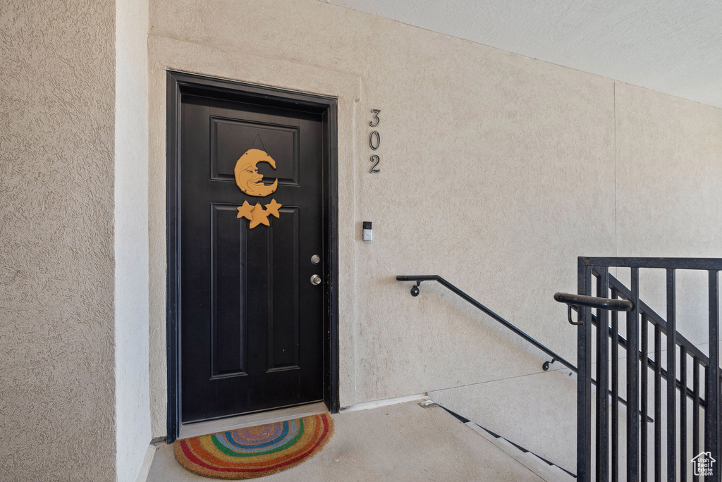Doorway to property with stucco siding