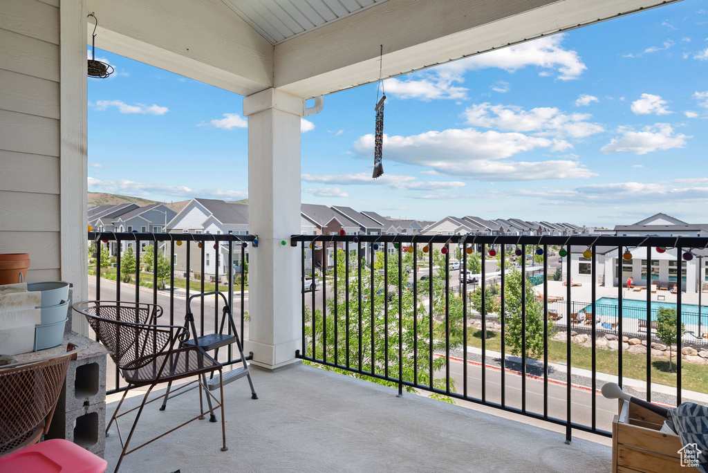 Balcony featuring a residential view and view of pool