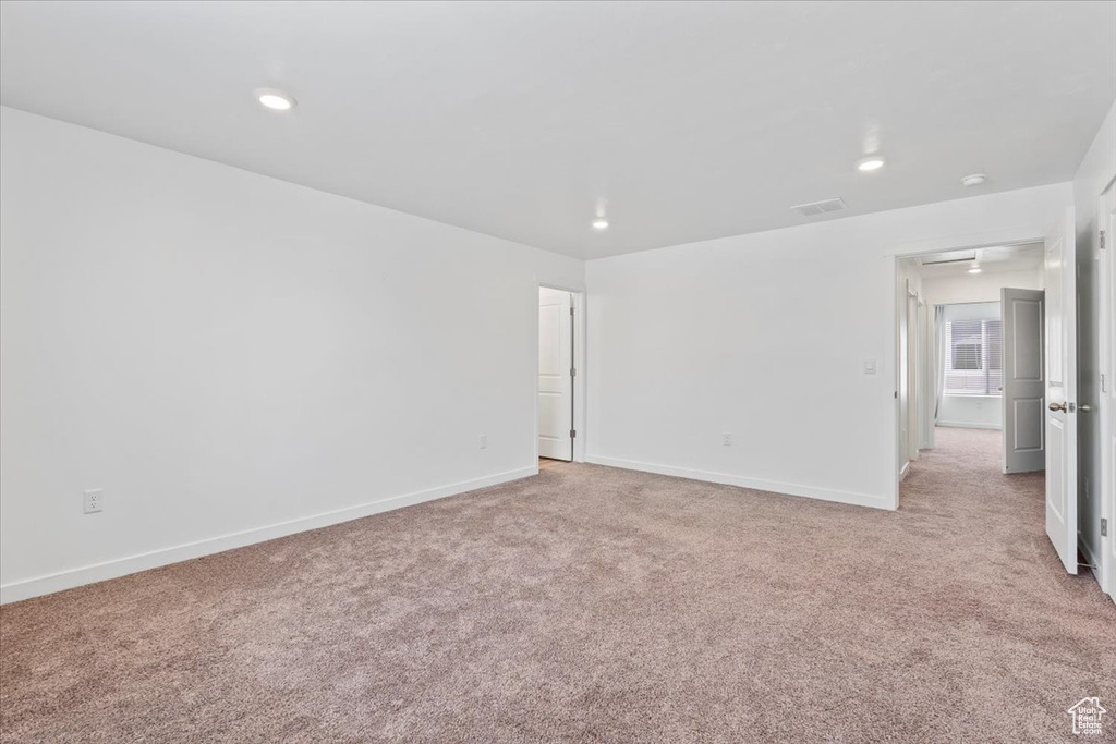 Spare room featuring light carpet and recessed lighting