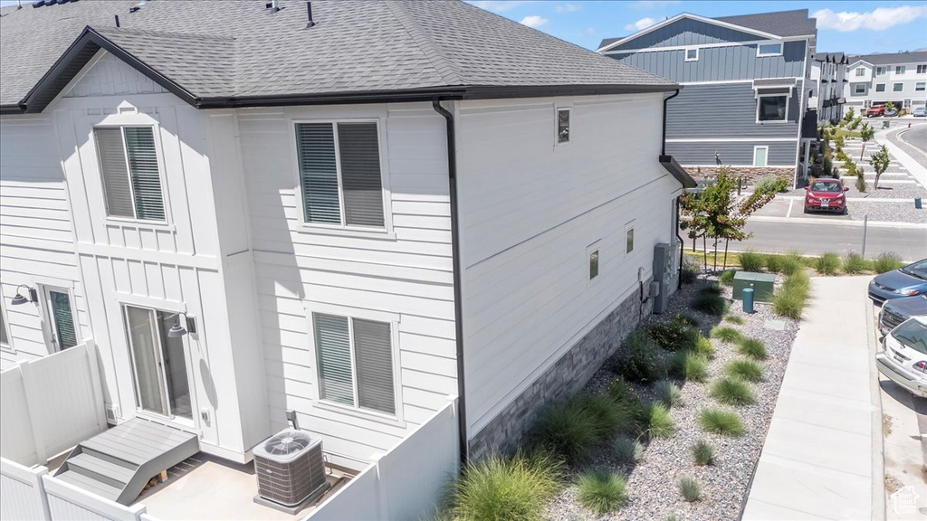 Back of property with a shingled roof