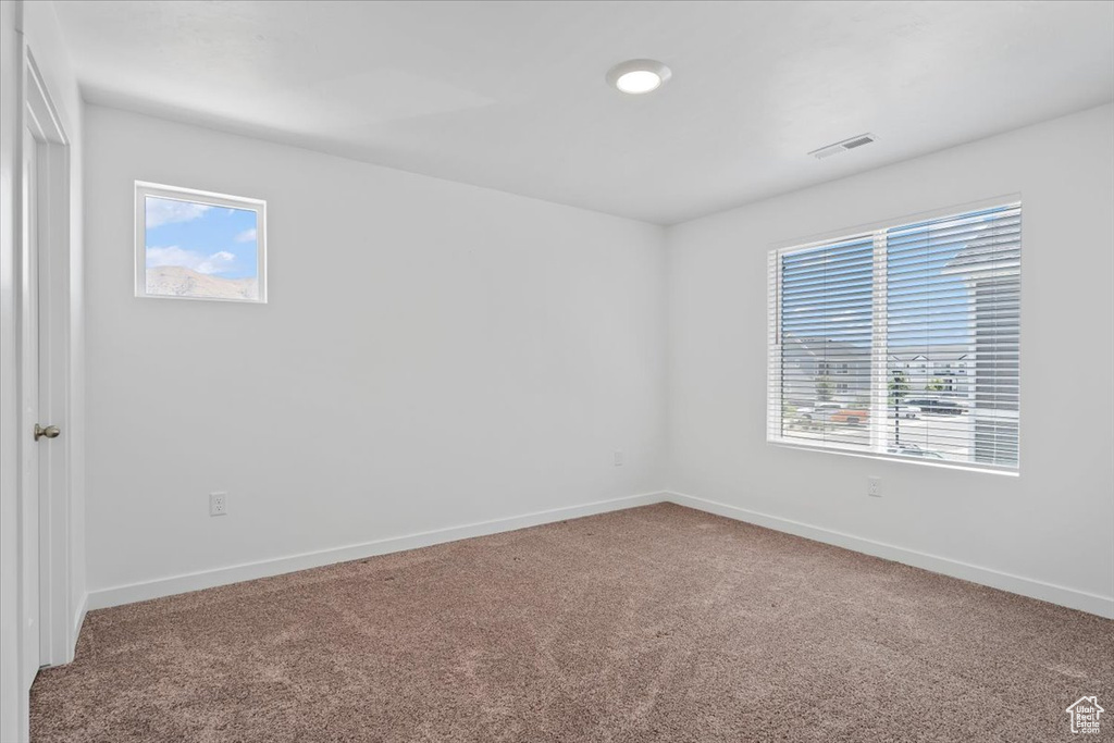 Carpeted empty room with plenty of natural light