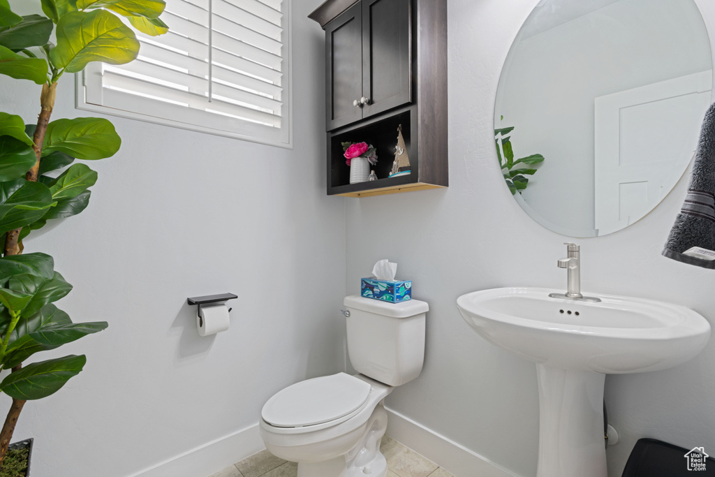 Bathroom with baseboards and tile patterned floors