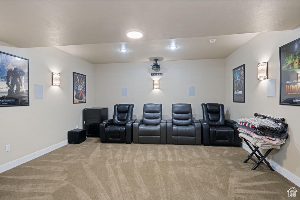 Home theater room with light colored carpet and recessed lighting