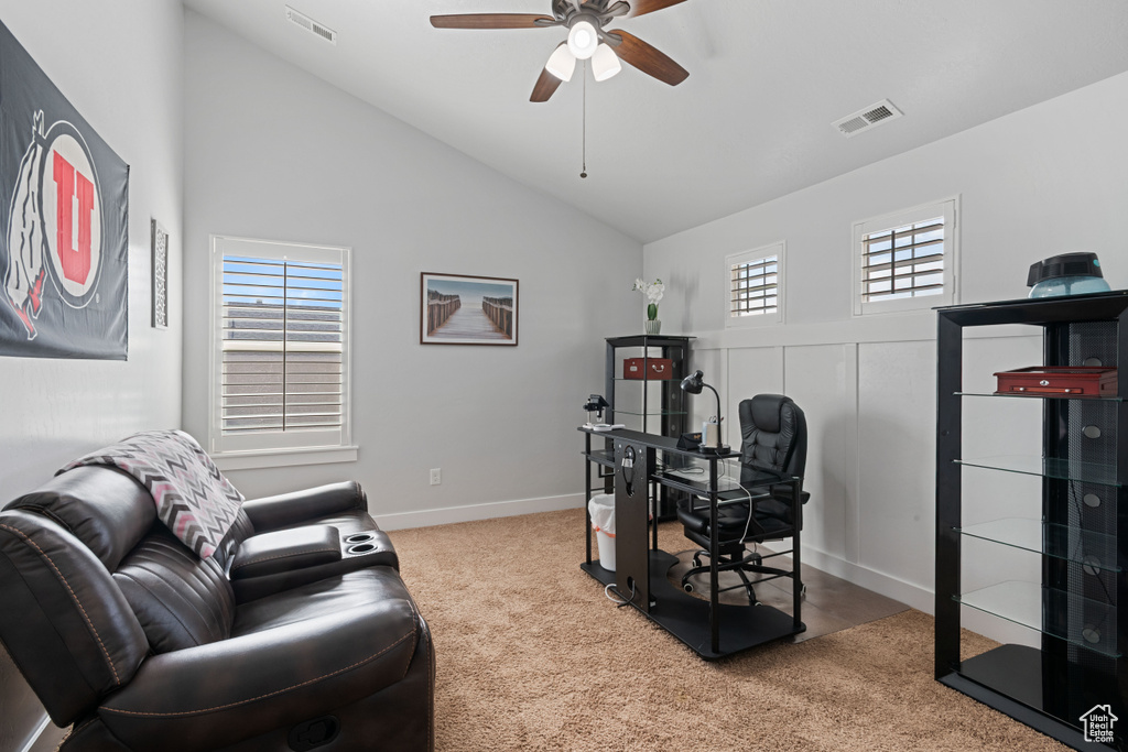 Carpeted home office with ceiling fan, lofted ceiling, and plenty of natural light