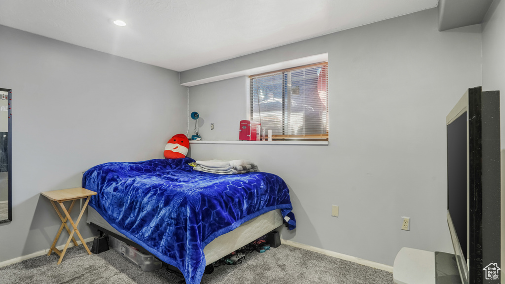 Bedroom with carpet flooring and baseboards