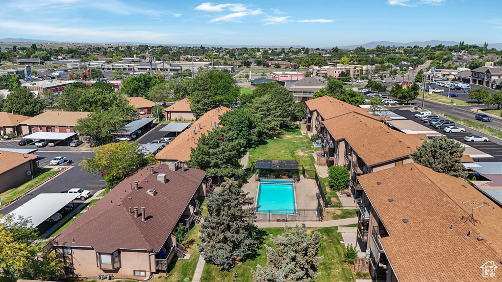 Aerial view of residential area with a pool area and a mountain backdrop