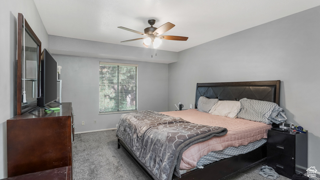 Carpeted bedroom with baseboards and ceiling fan