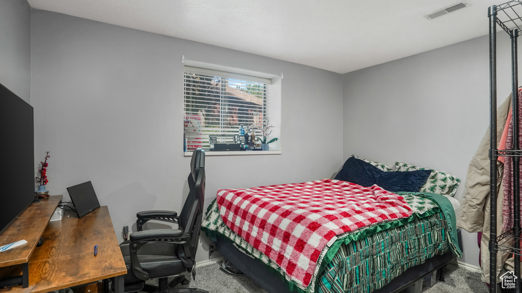 Bedroom featuring carpet floors and a desk