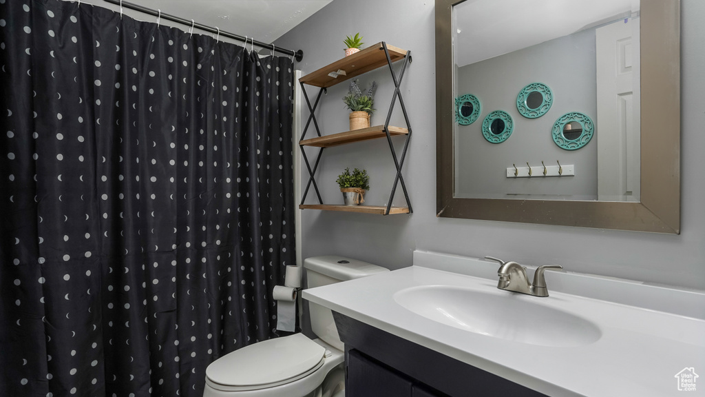 Bathroom featuring vanity and a shower with shower curtain