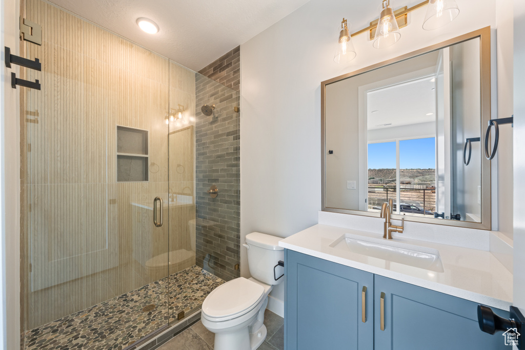 Bathroom with a stall shower and vanity