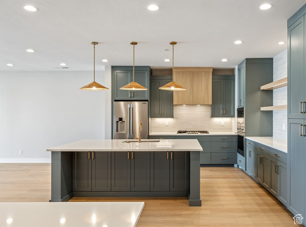 Kitchen featuring stainless steel appliances, light wood finished floors, light countertops, decorative backsplash, and open shelves