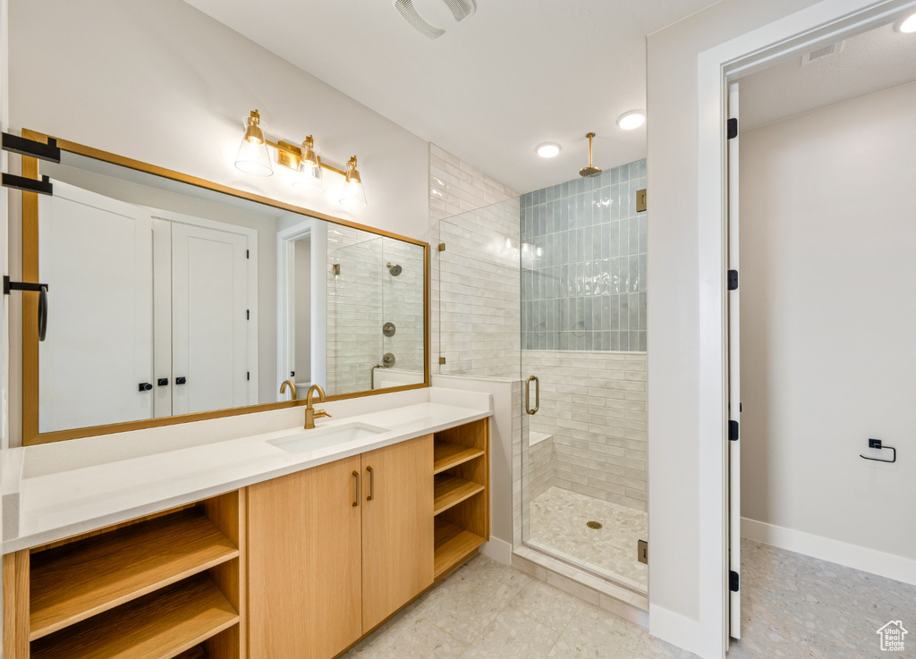 Bathroom with a shower stall and vanity