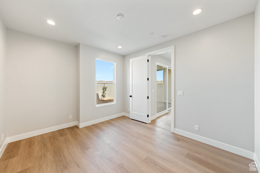 Spare room with light wood finished floors and recessed lighting