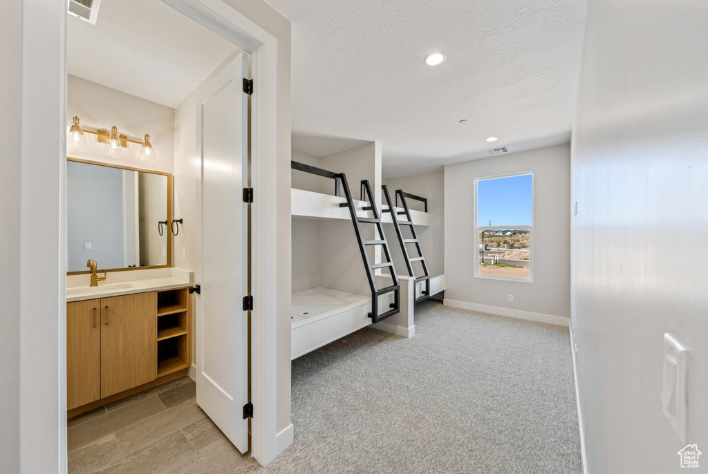 Corridor featuring recessed lighting and light colored carpet