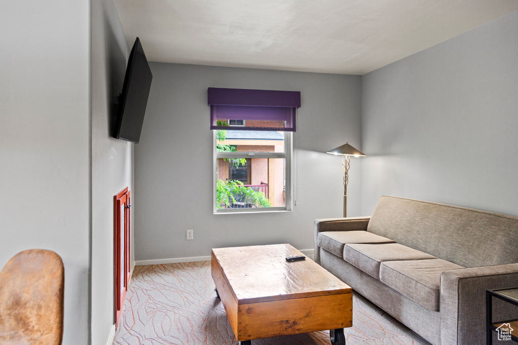 Living room with baseboards and carpet