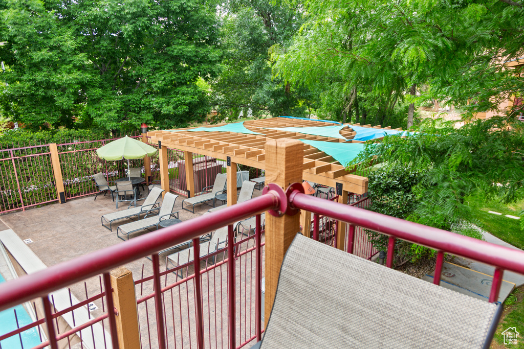 Wooden terrace with a patio area and view of wooded area