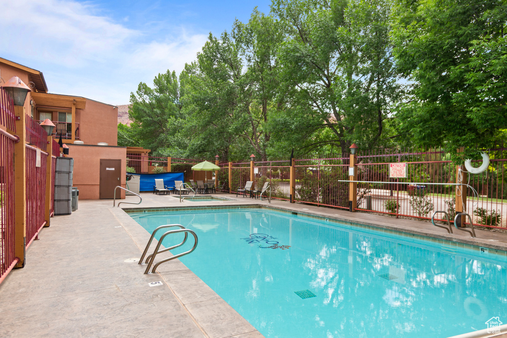 Community pool with a patio