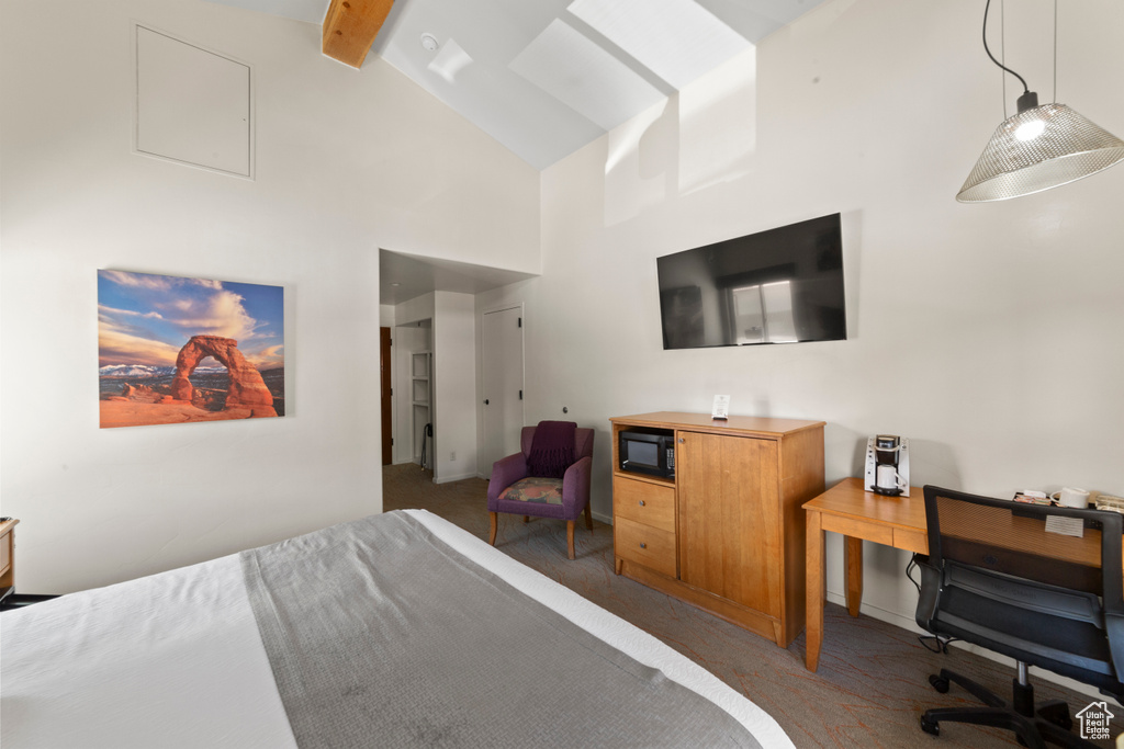 Bedroom with carpet flooring, beamed ceiling, high vaulted ceiling, and a desk