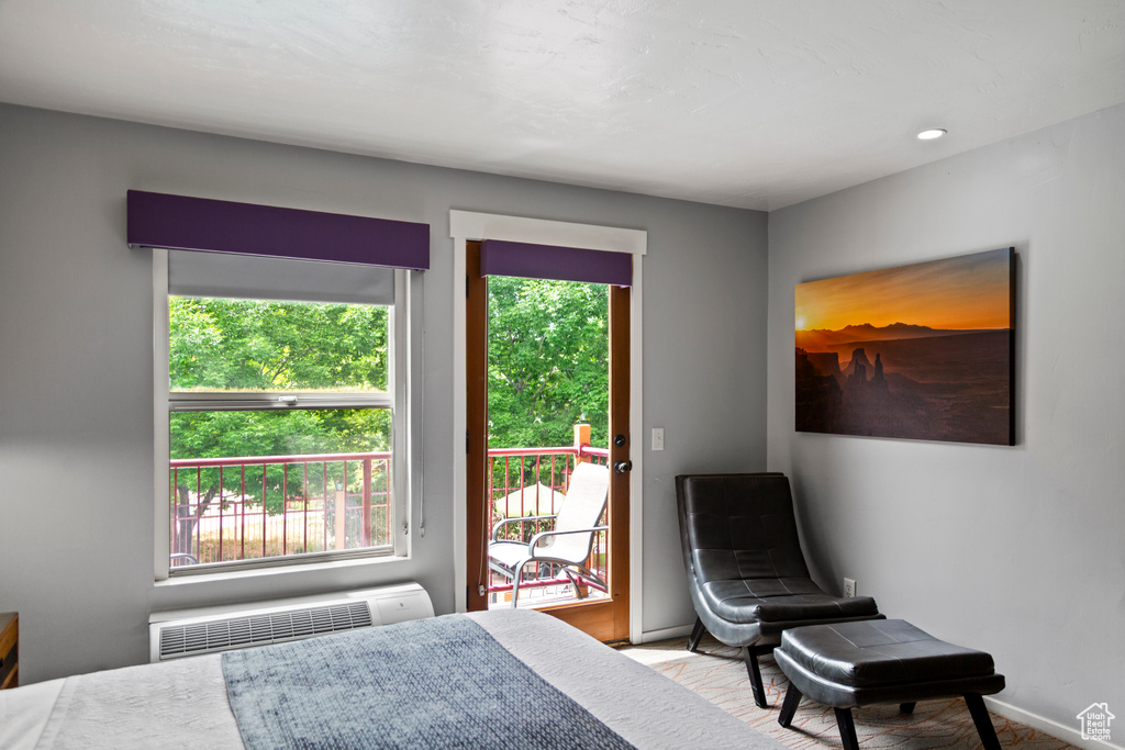 Bedroom featuring radiator heating unit and access to outside