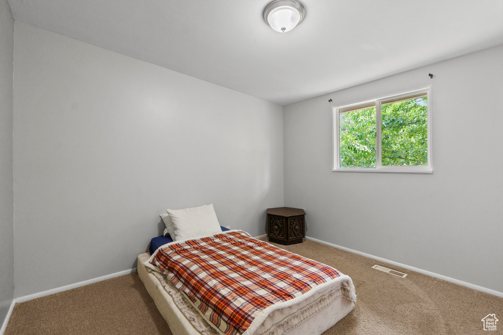 Carpeted bedroom with baseboards