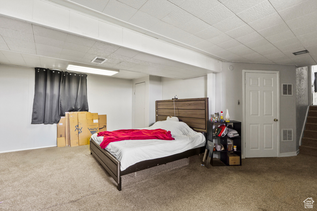 Carpeted bedroom featuring baseboards