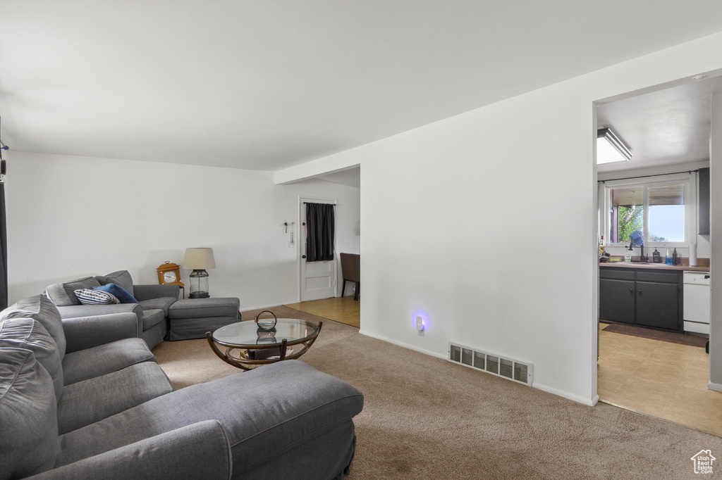 Living room featuring light colored carpet and baseboards
