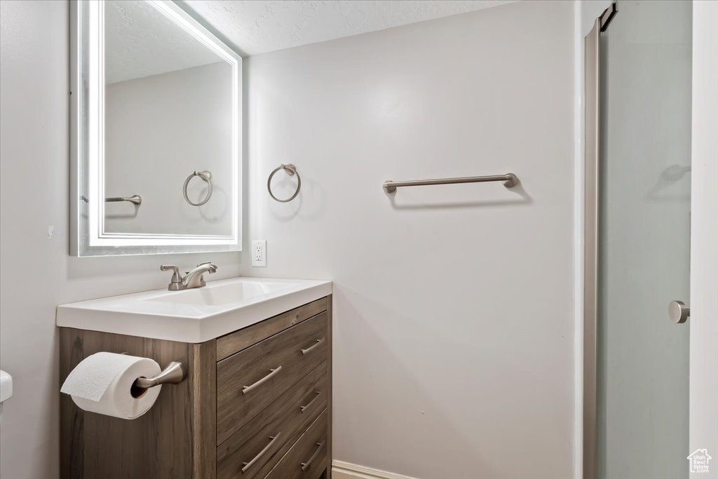 Bathroom with vanity and a textured ceiling