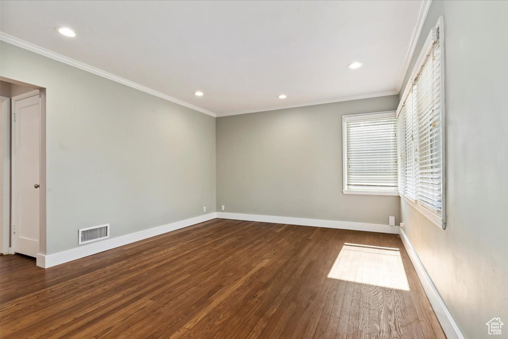 Unfurnished room with wood finished floors, ornamental molding, and recessed lighting